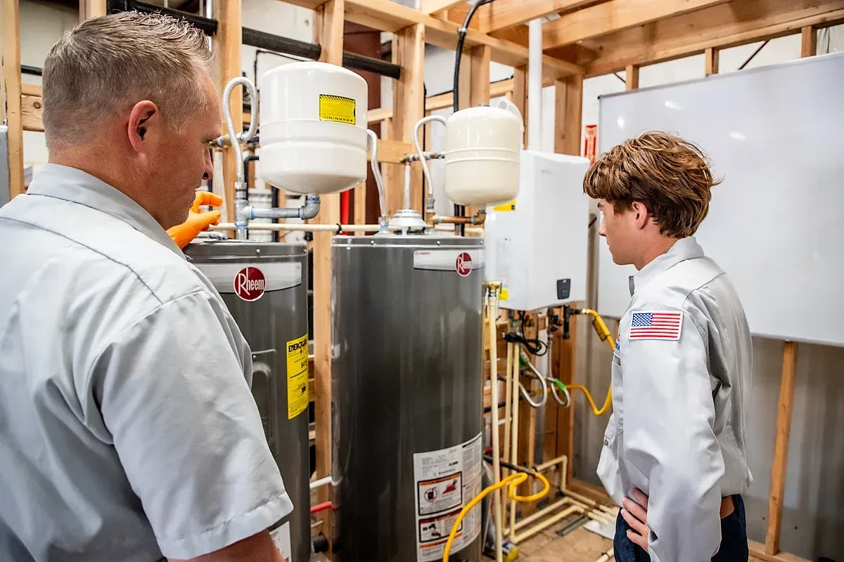 Water heater system being looked at by technicians