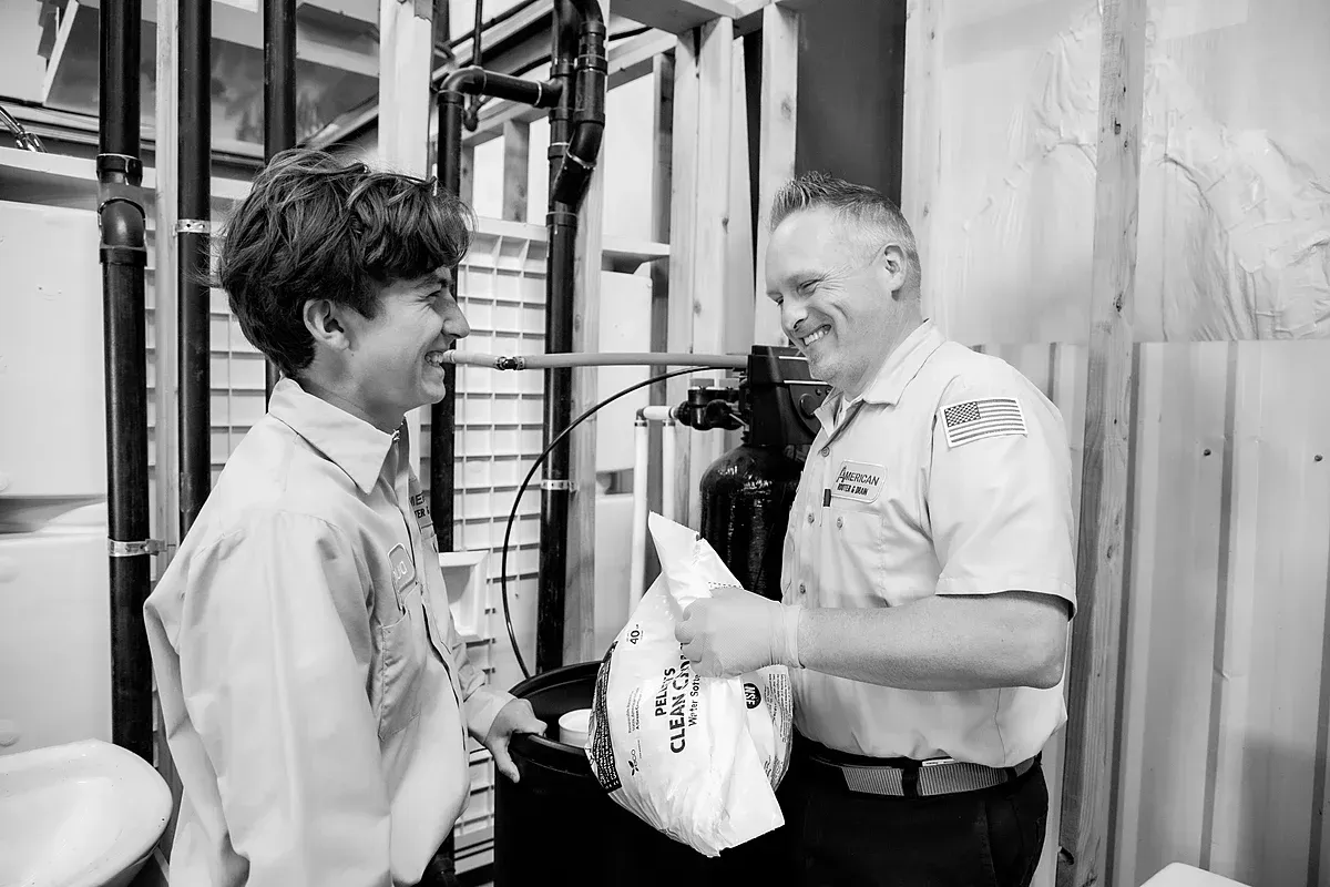 Techs preparing water softener treatment