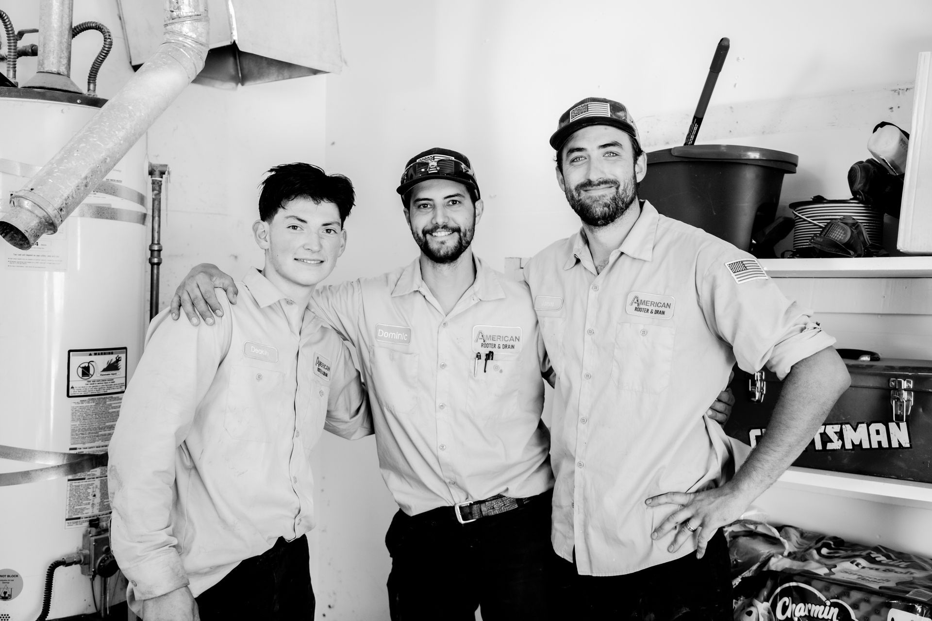 3 HVAC Techs at a job where they are working on installing a new system and stopped to smile for group pic.
