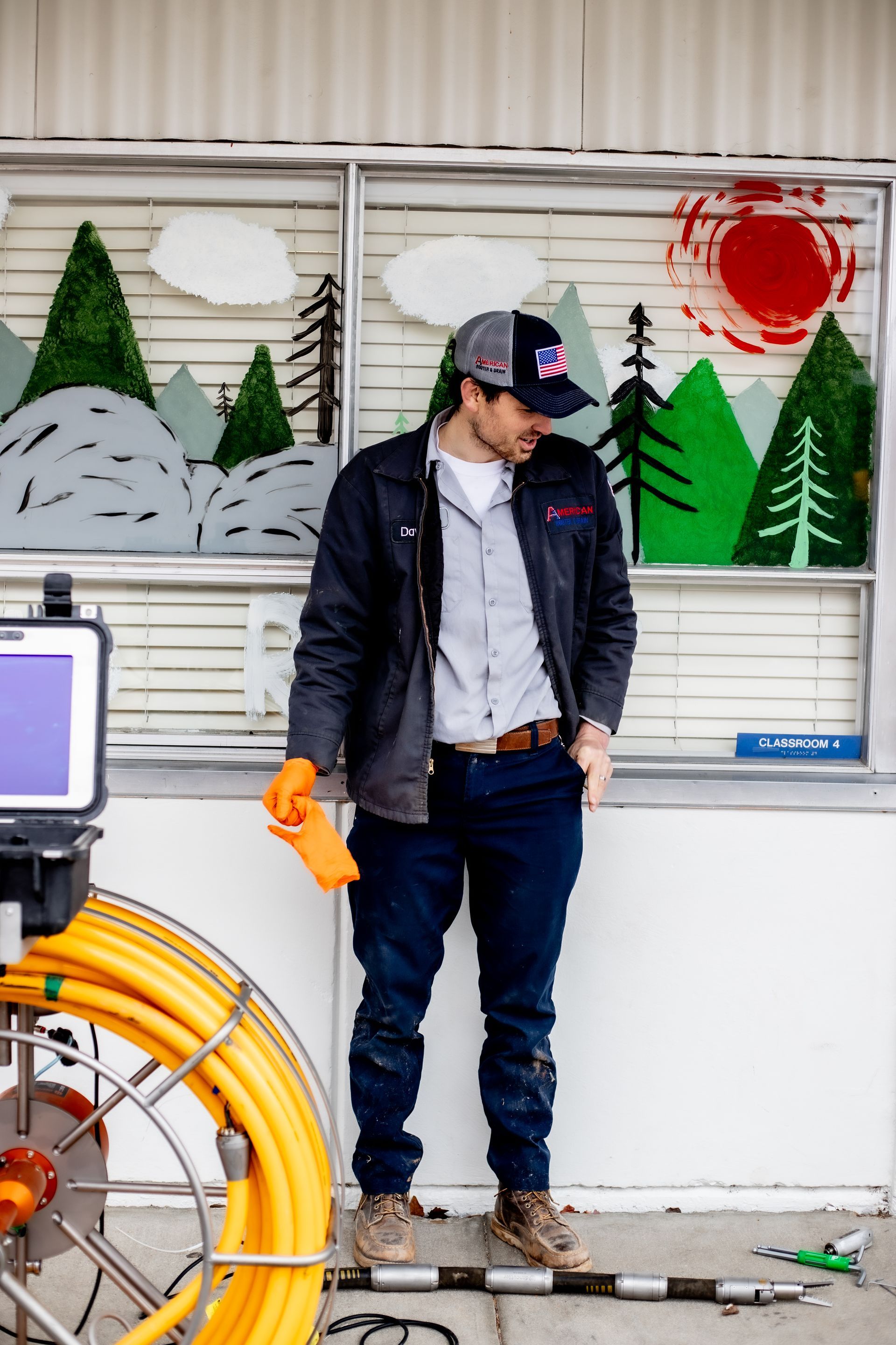 Drain technicians and underground plumbing crew working an elementary school to replace busted pipes