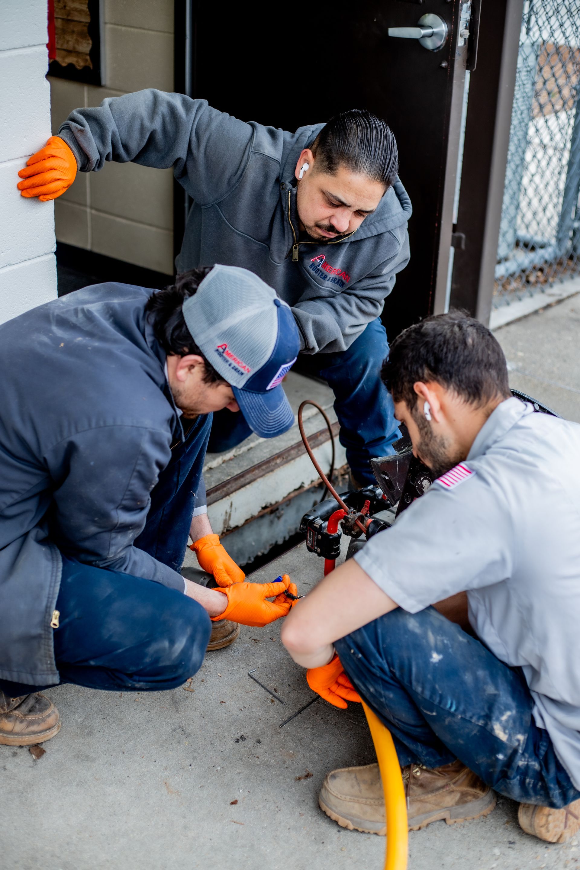 Drain technicians and underground plumbing crew working an elementary school to replace busted pipes