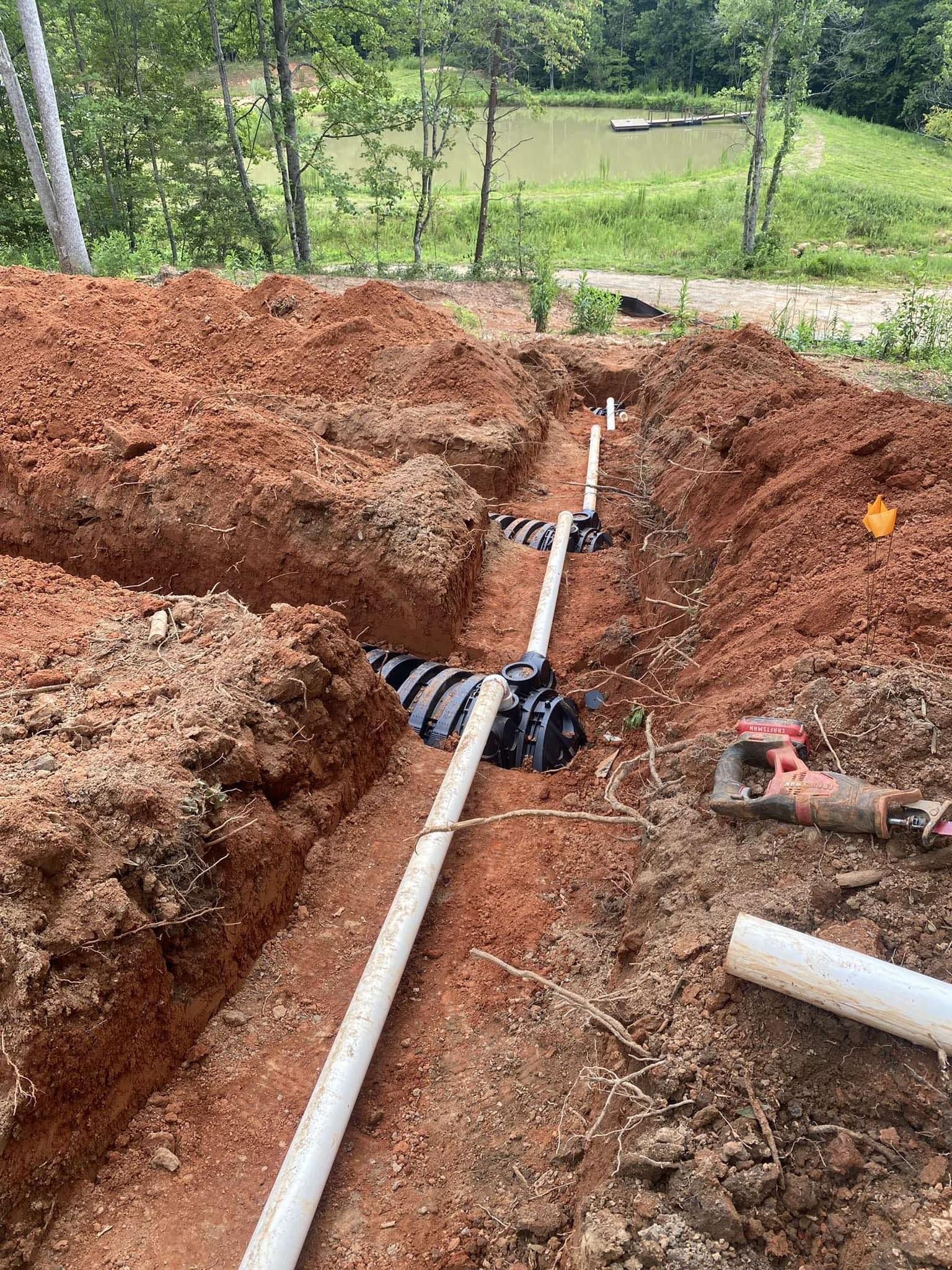 A pipe is being installed in a hole in the ground.