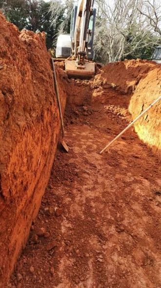 A bulldozer is digging a hole in the dirt.