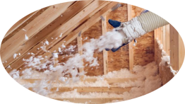 Une personne souffle de l'isolant dans le grenier d'une maison