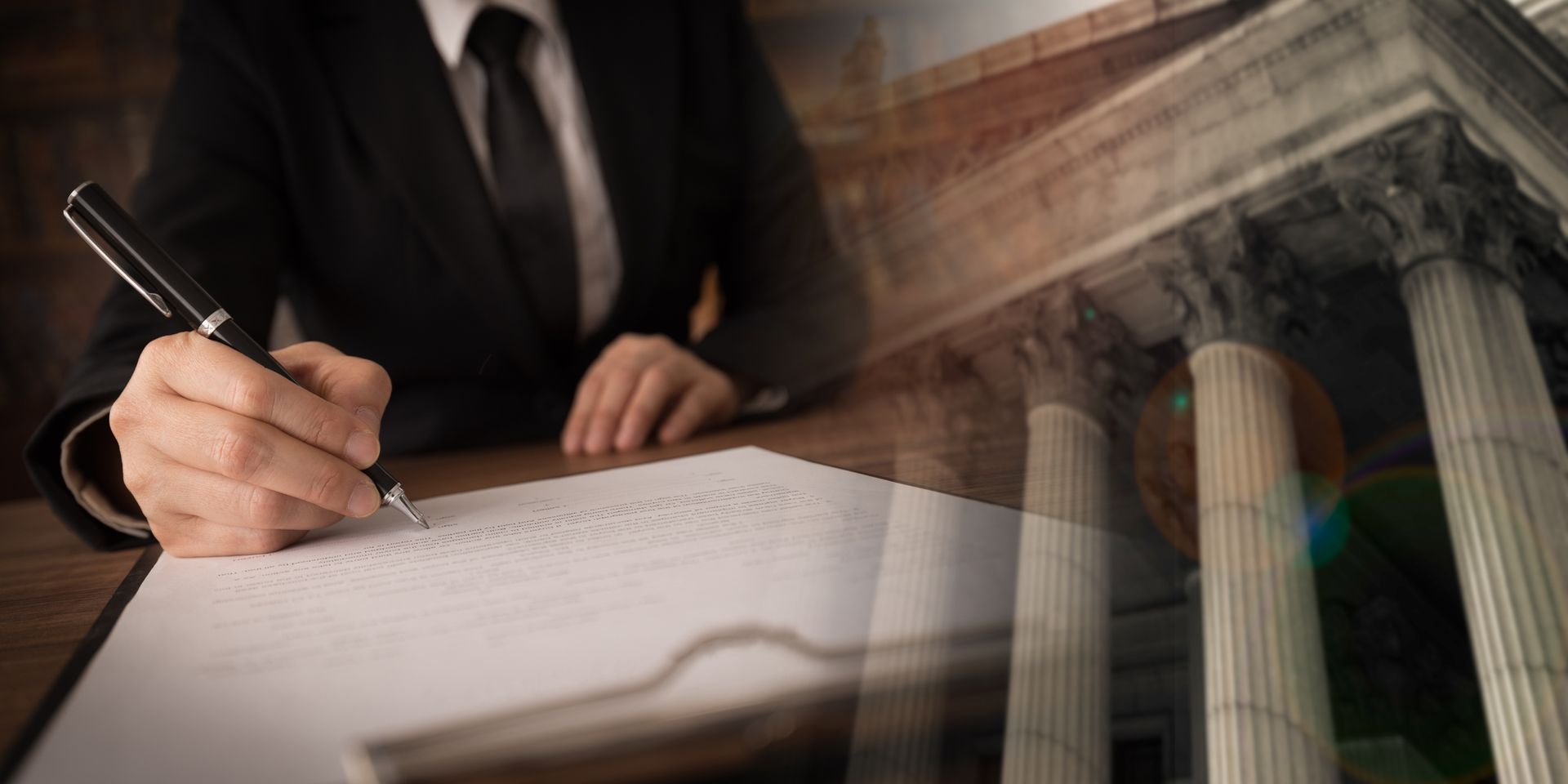 A person in a suit signing a document, overlaid with the pillars of a courthouse.