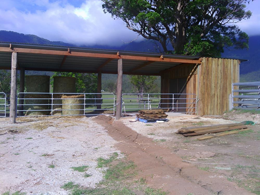 A Fenced In Area With Hay Bales And A Tree In The Background — Lawrence Williams Fencing in Goolmangar, NSW
