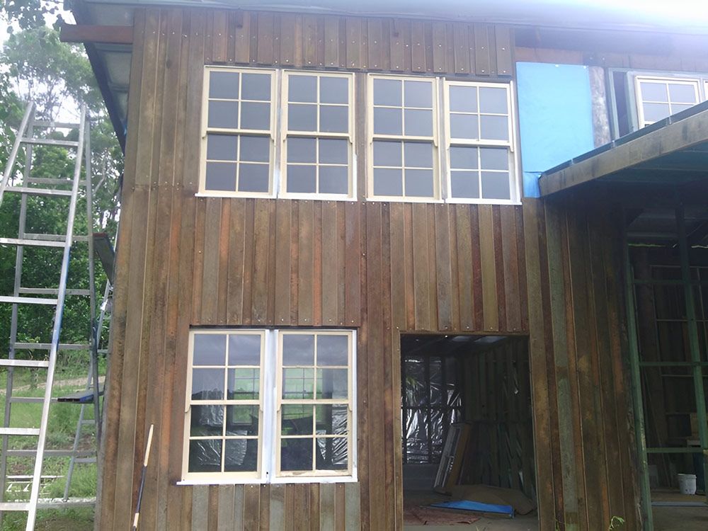 Building A Wooden House With A Ladder In Front Of It  — Lawrence Williams Fencing in Goolmangar, NSW