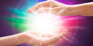 A person is holding a light in their hands.