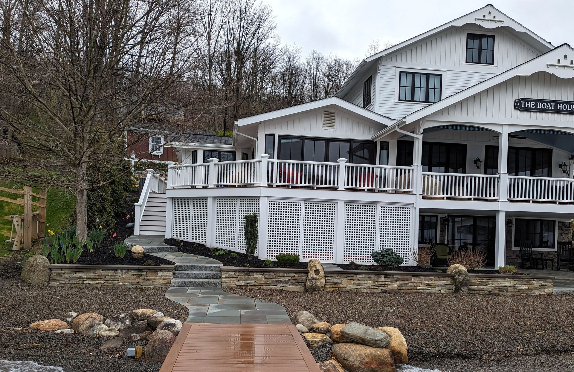 A large white house with a dock in front of it