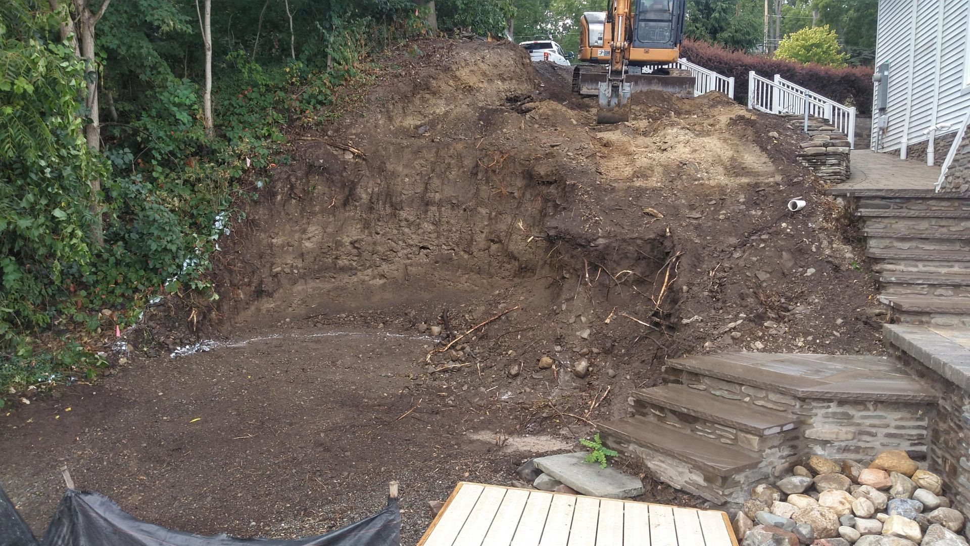 A large pile of dirt is being excavated by a bulldozer