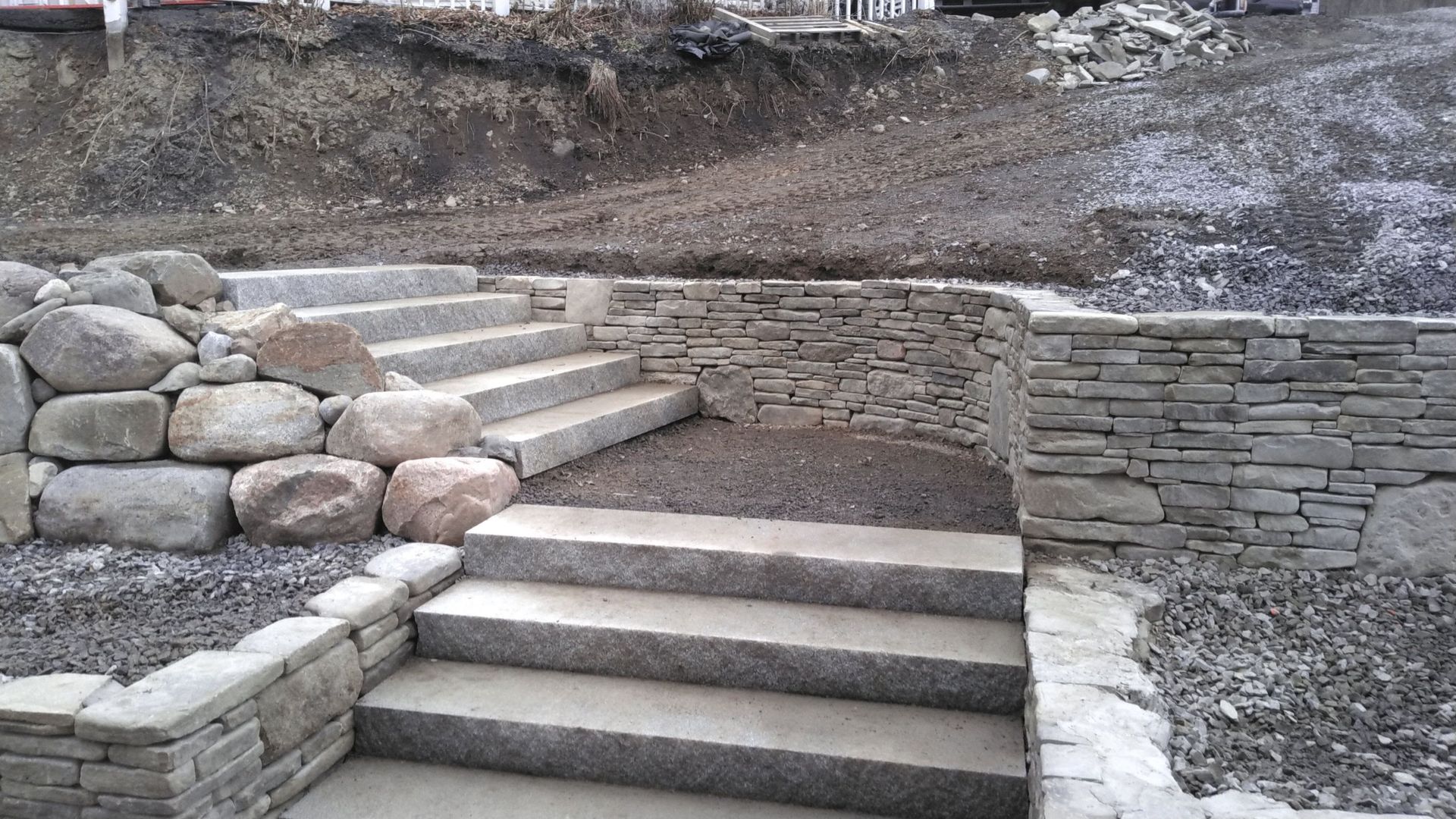 A stone wall with stairs leading up to it