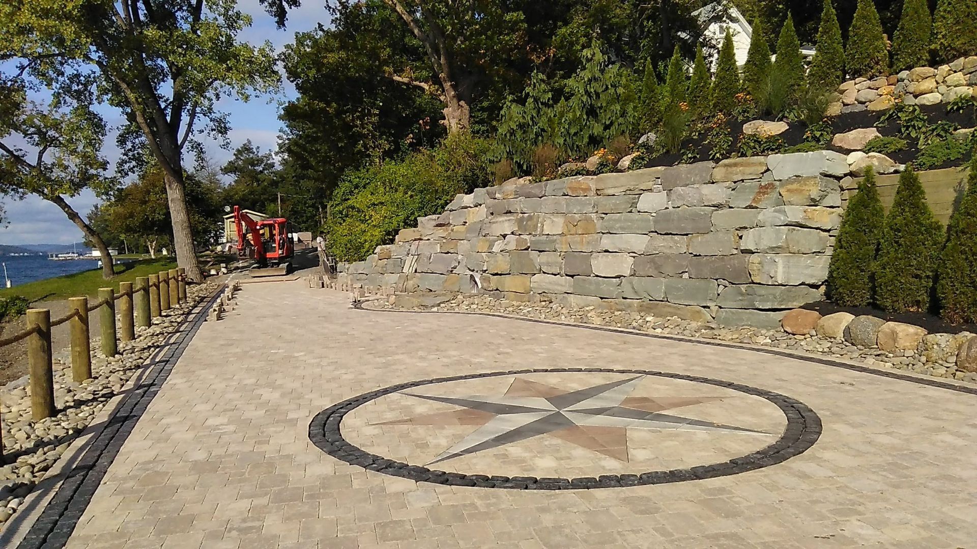 A brick driveway with a compass design in the middle