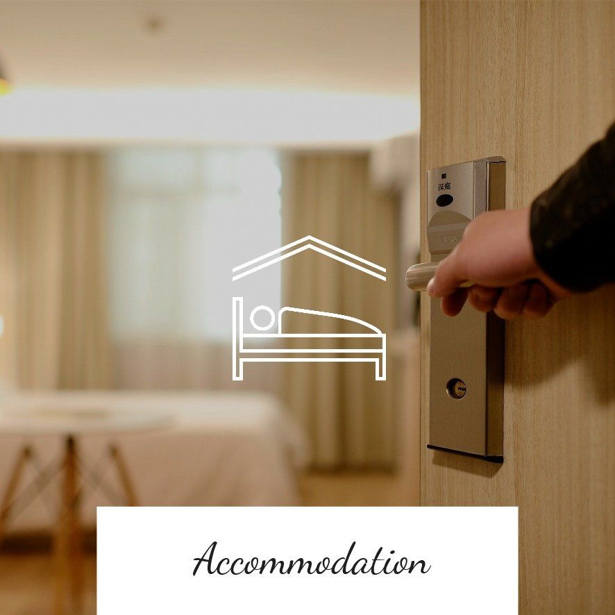 Person opening a hotel room door; bed in the background;