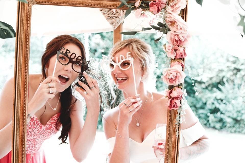 Two women smiling, holding