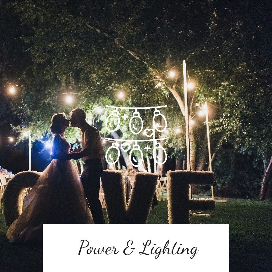Couple kissing at night, illuminated by string lights and