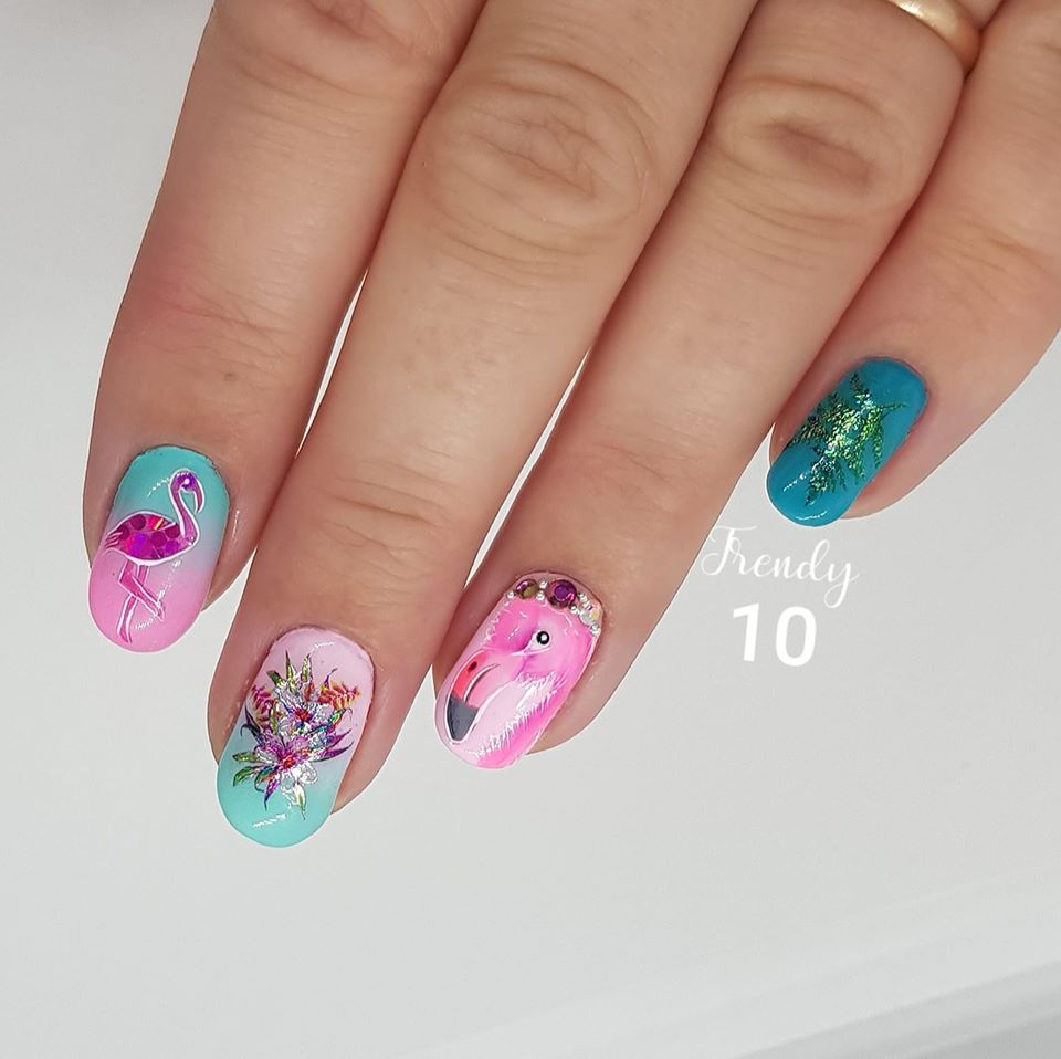 Hand with vibrant, decorated nails; a flamingo design with flowers and teal accents.