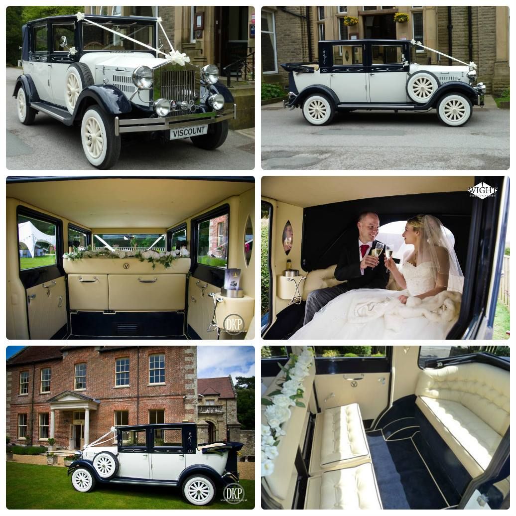 Classic wedding car: Black and white vintage car decorated with flowers. Bride and groom inside.