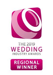 Logo for The 2019 Wedding Industry Awards. Features a magenta and white emblem, text, and