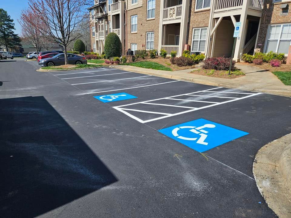 A parking lot with a handicap sign painted on it
