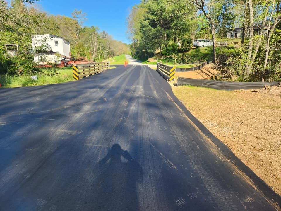 A person is taking a picture of a newly paved road