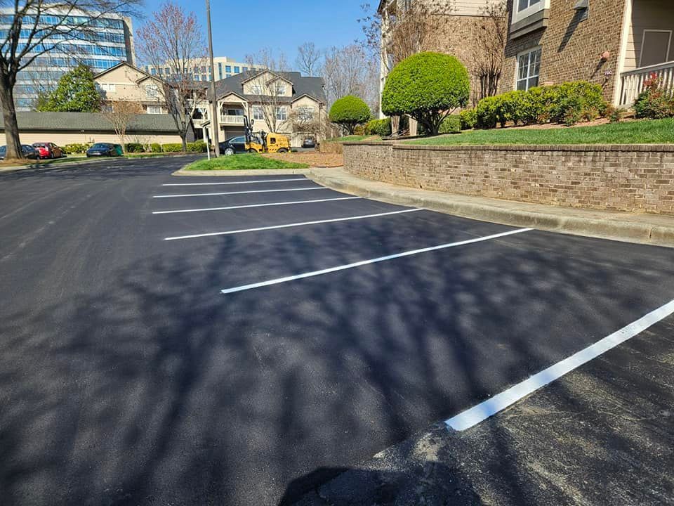 A parking lot with white lines on it in front of a building
