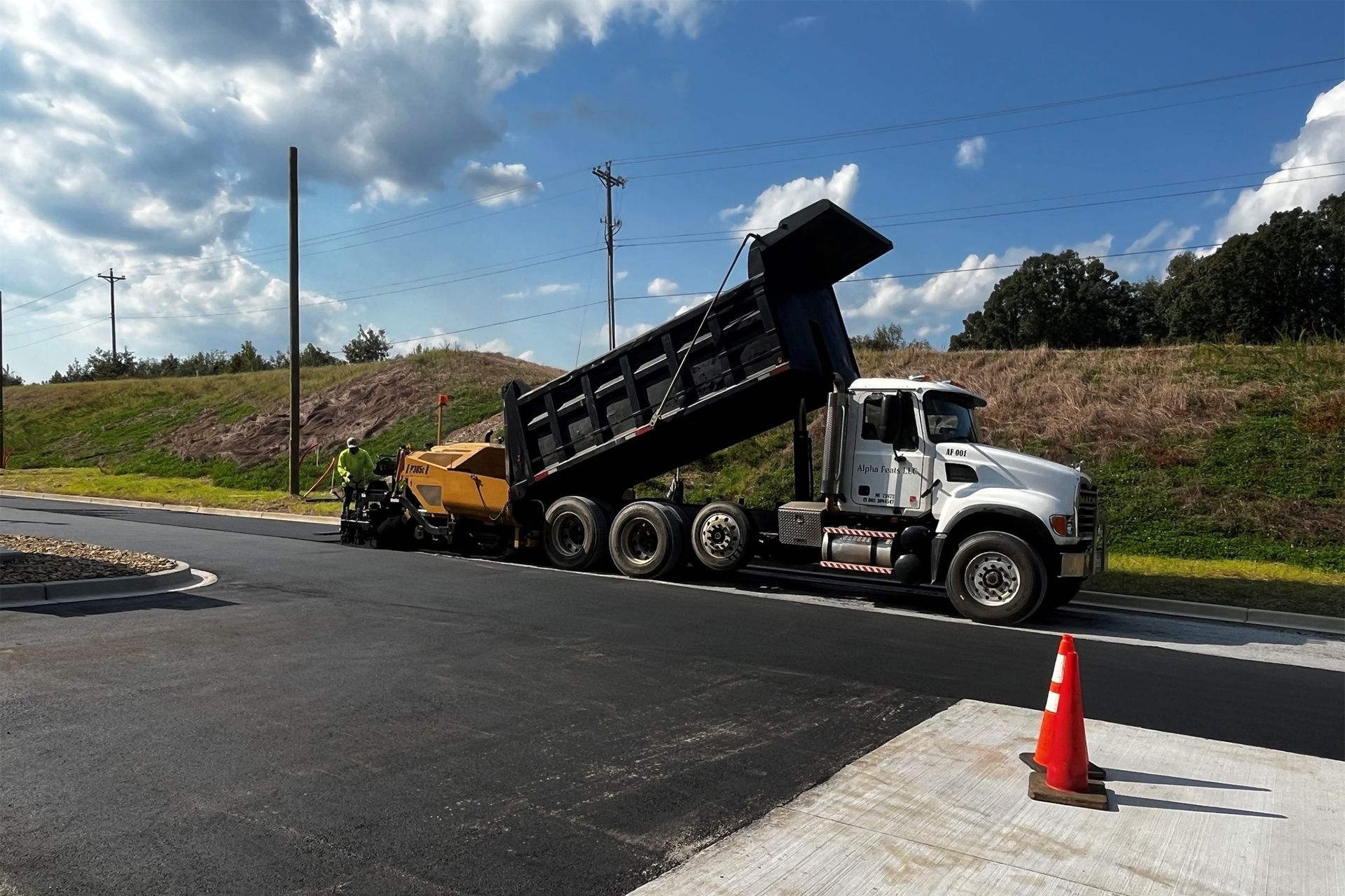 A dump truck is driving down a road