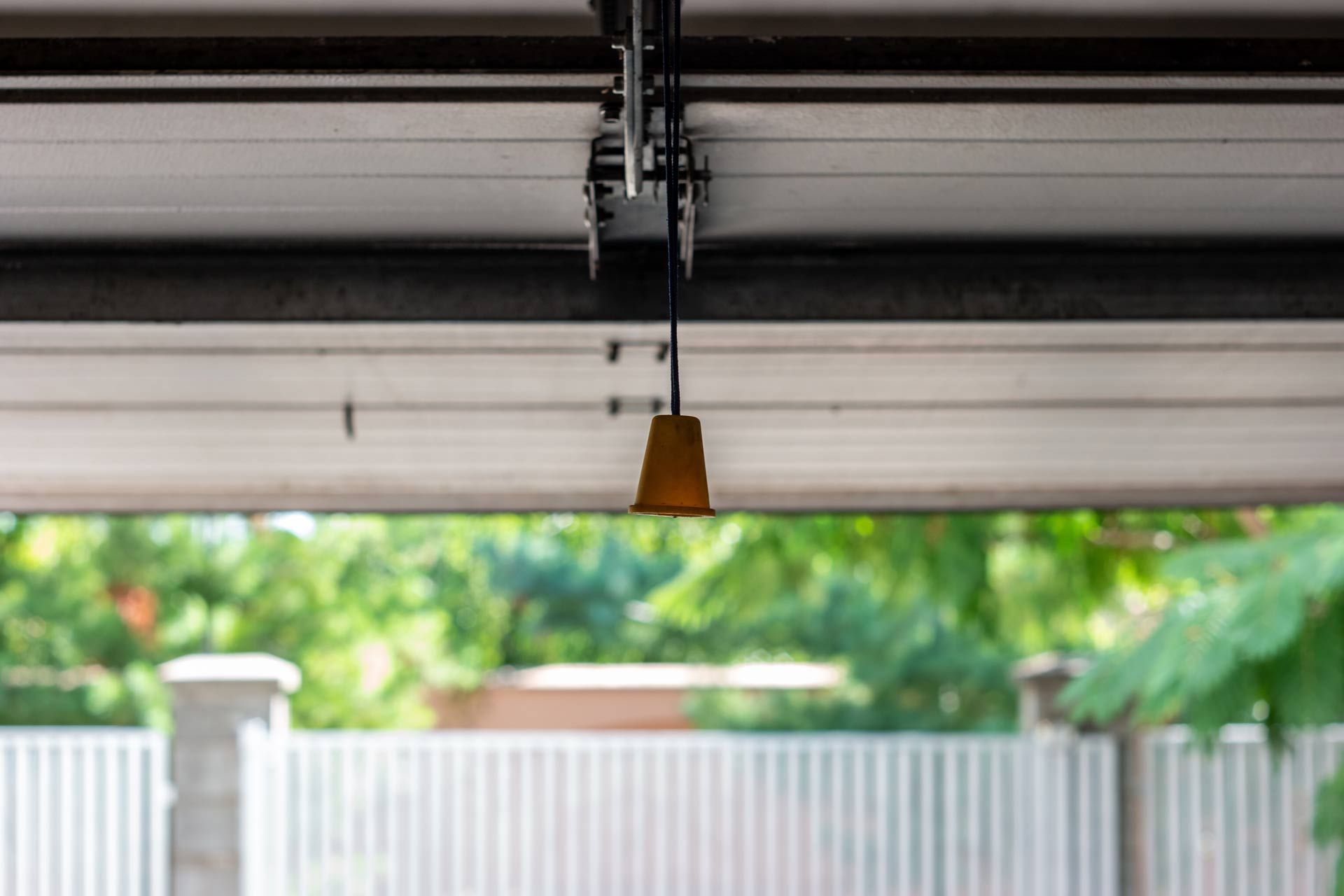 Close-up of a manual cable operated garage door from the inside of a garage