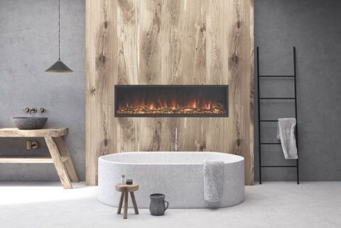 Bathroom with oval tub, wood accent wall, and electric fireplace.