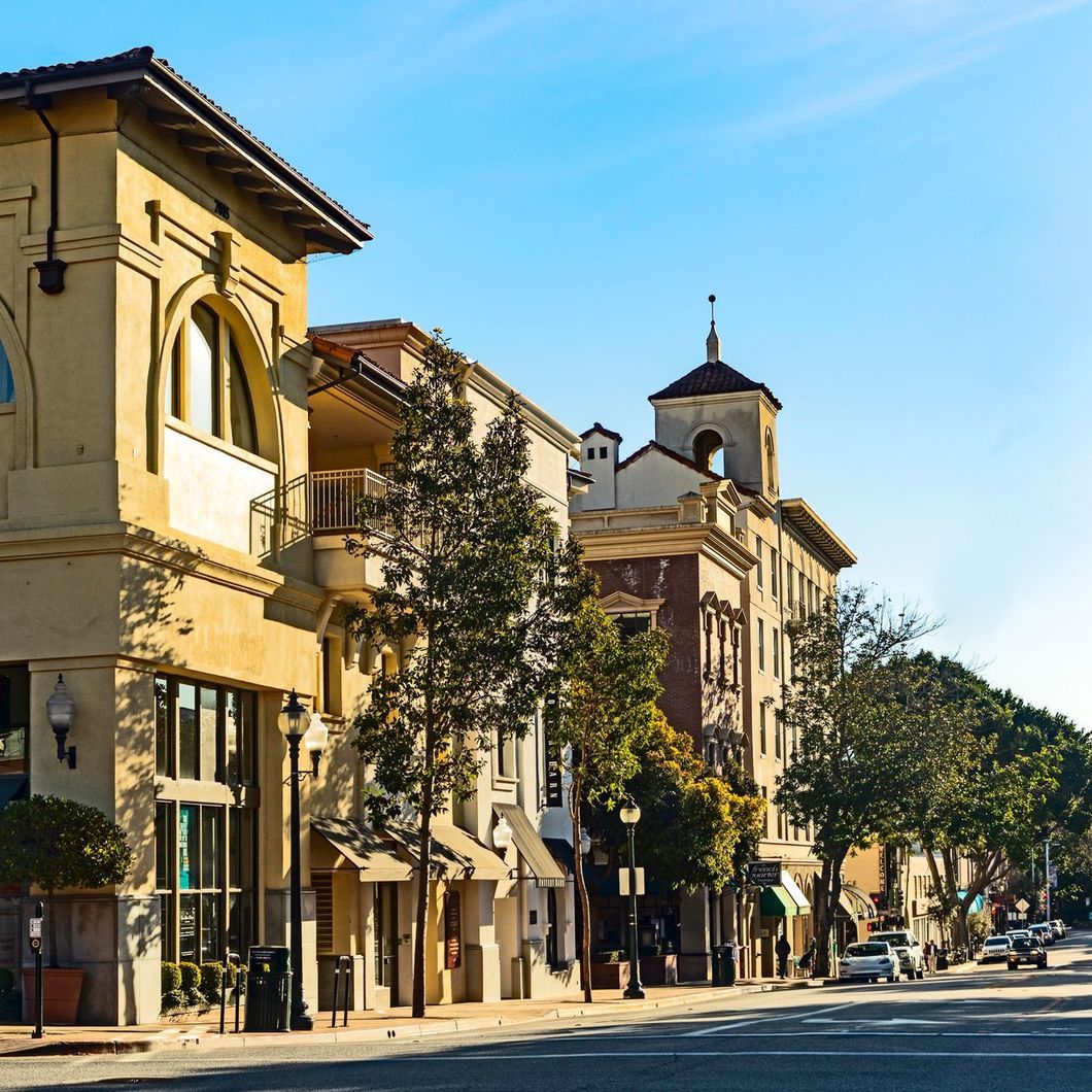 A row of buildings on the side of a street