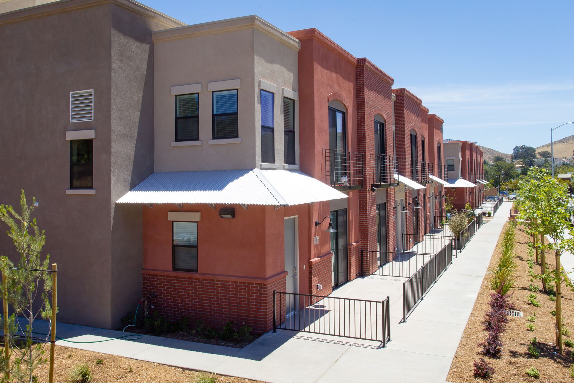 A row of apartment buildings with a walkway between them