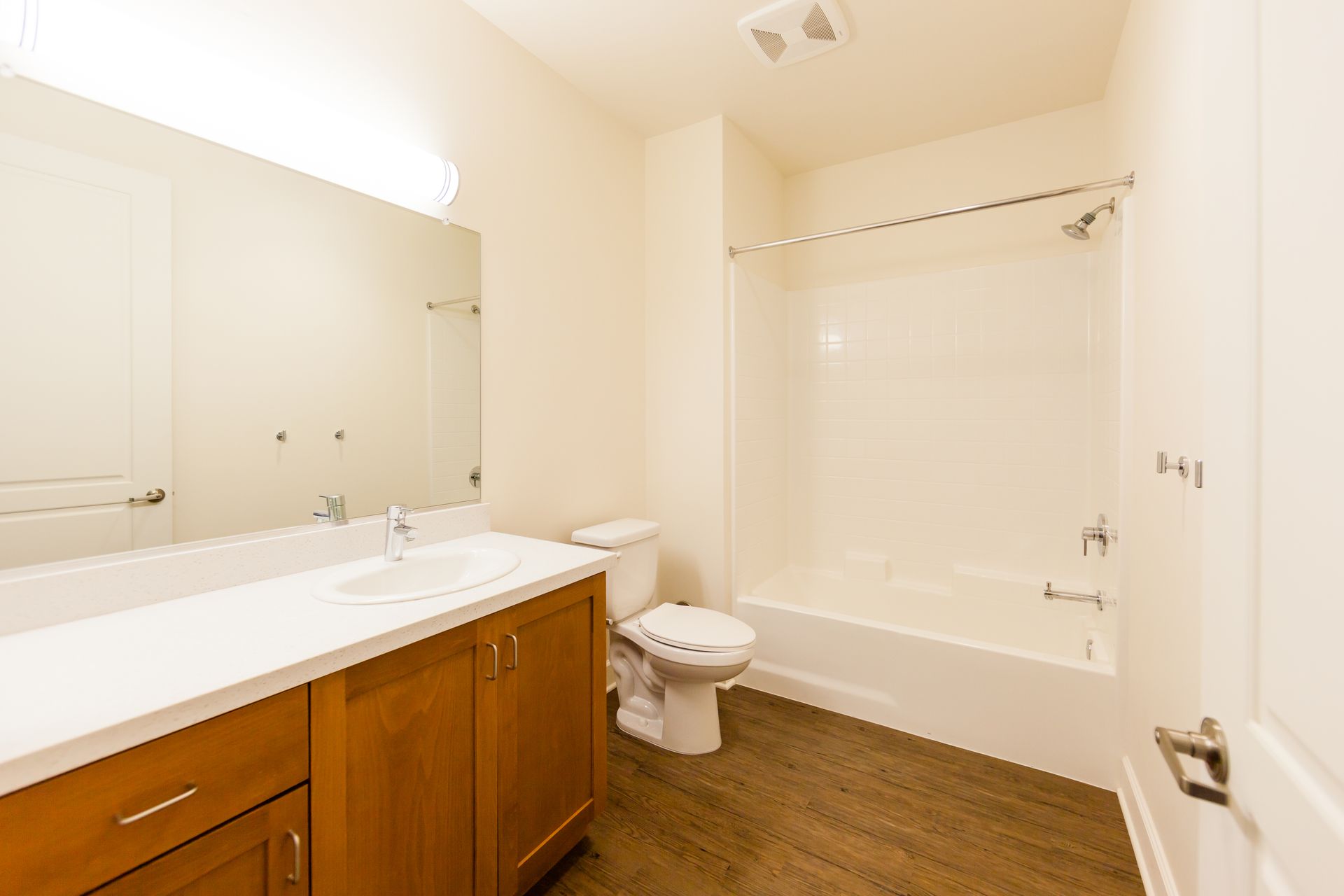 A bathroom with a toilet , sink , and bathtub.