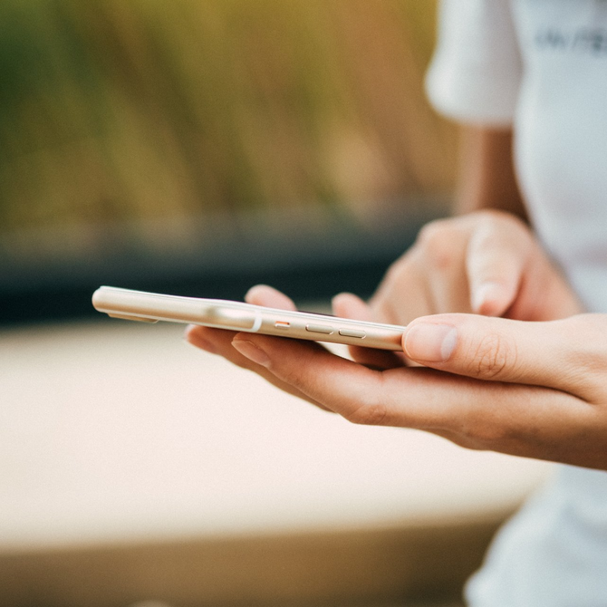 A person is holding a cell phone in their hand