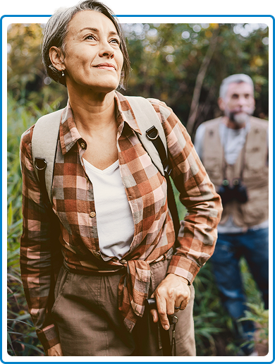 A woman hiking with her husband following close behind