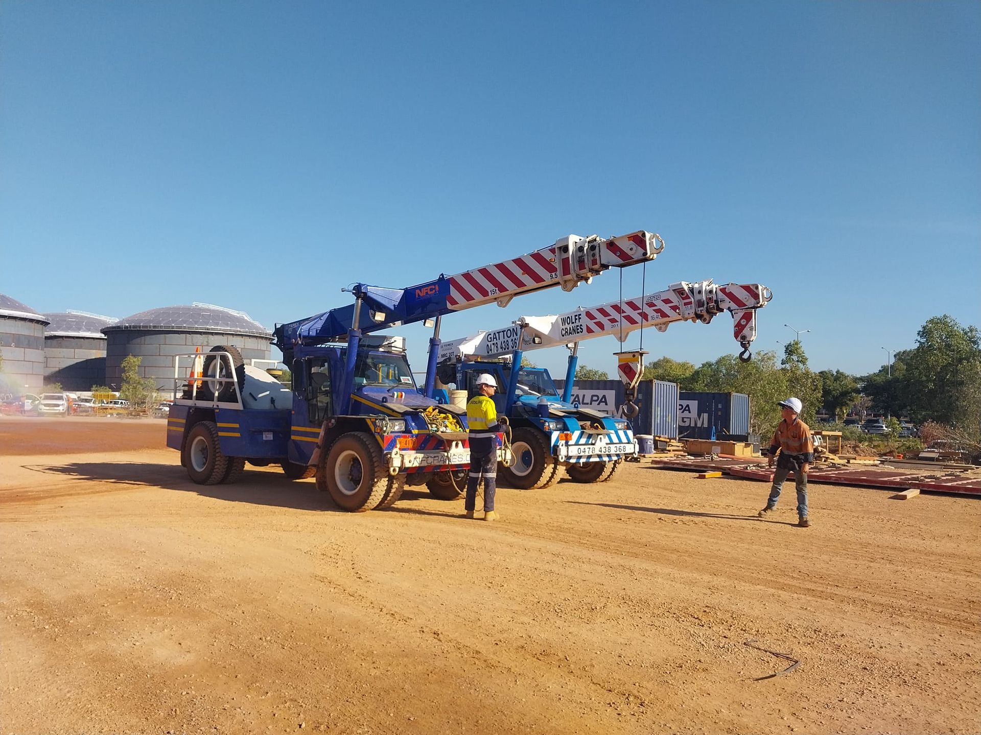 Two Construction Workers Are Standing in Front of A Crane on A Dirt Road — Northern Franna Cranes NT in Noonamah, NT