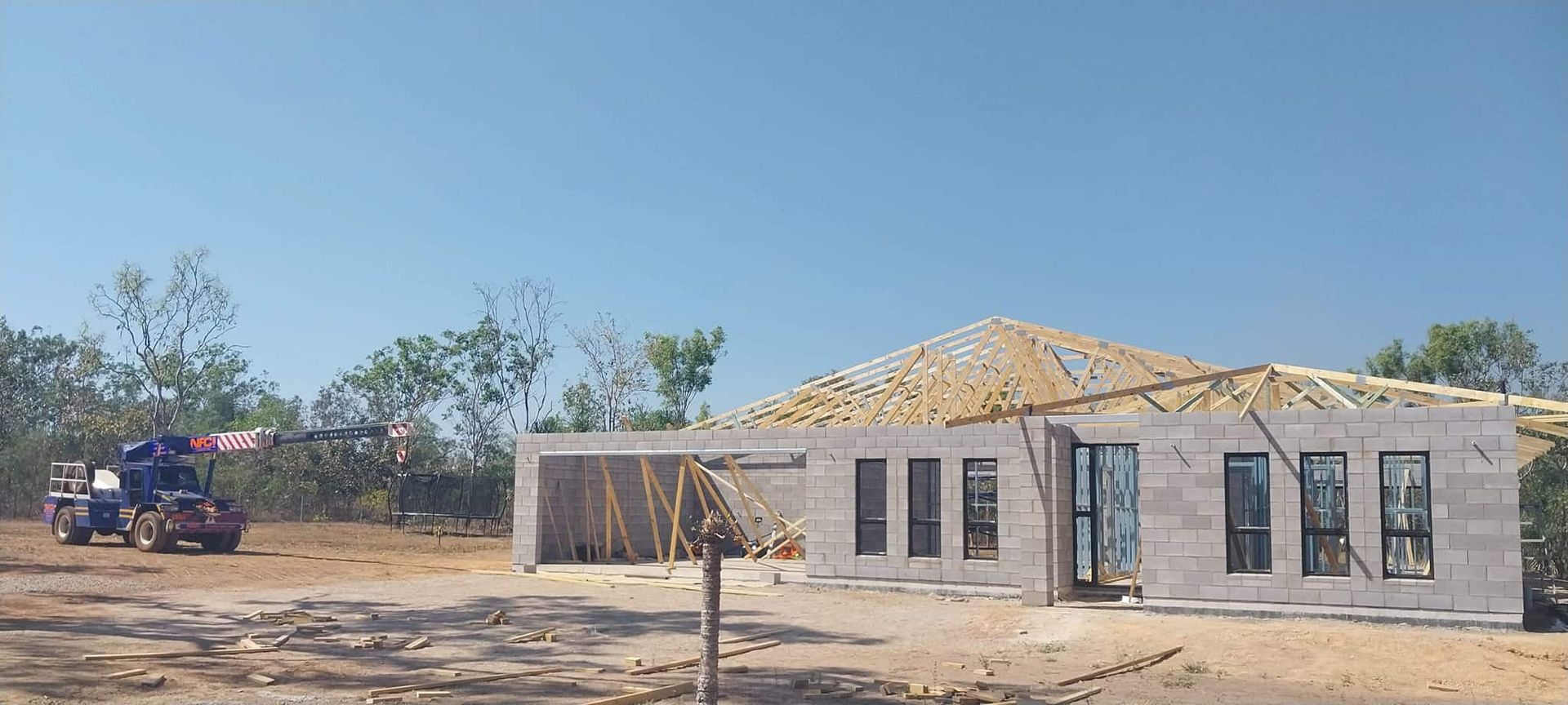 A Car is Parked in Front of a Building Under Construction — Northern Franna Cranes NT in Katherine, NT