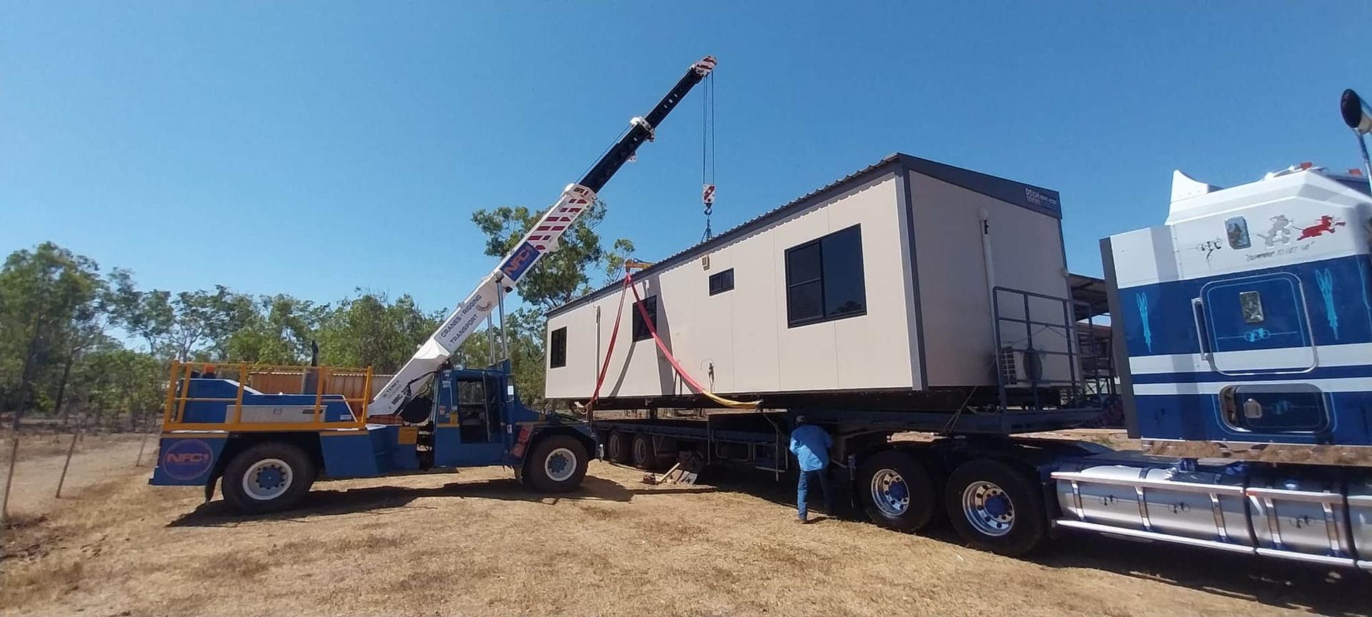 A Crane is Lifting a Trailer With a House on It — Northern Franna Cranes NT in Palmerston, NT
