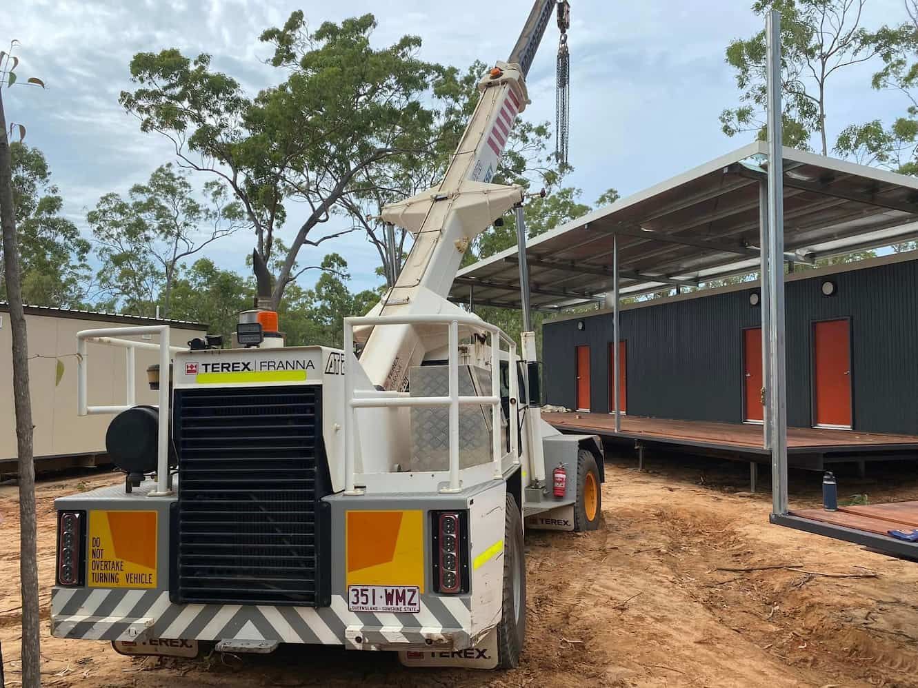 A Truck with A Crane Attached to It Is Parked in Front of A Building Under Construction — Northern Franna Cranes NT in Noonamah, NT