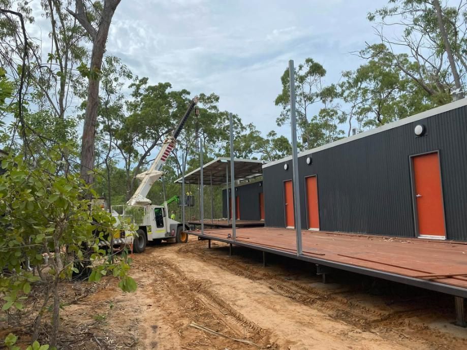 A Crane Is Being Used to Build a House in The Woods — Northern Franna Cranes NT in Noonamah, NT