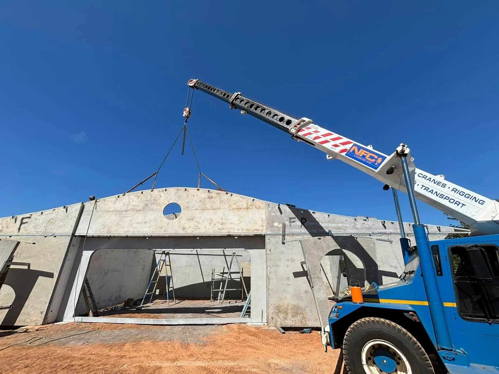 A Crane Is Lifting a Piece of Concrete on Top of A Building — Northern Franna Cranes NT in Noonamah, NT