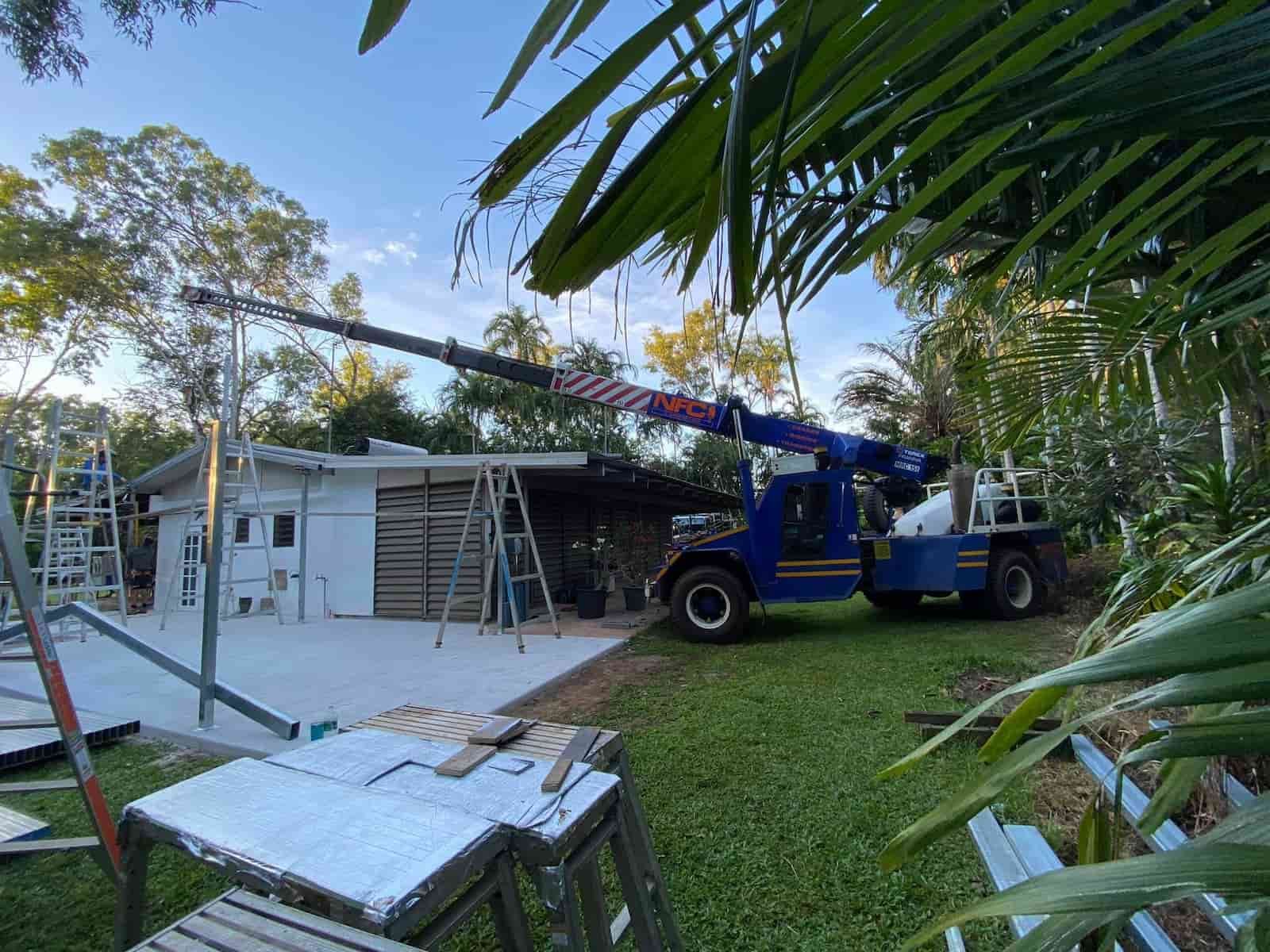 A Blue Truck with A Crane Is Parked in Front of A House — Northern Franna Cranes NT in Noonamah, NT