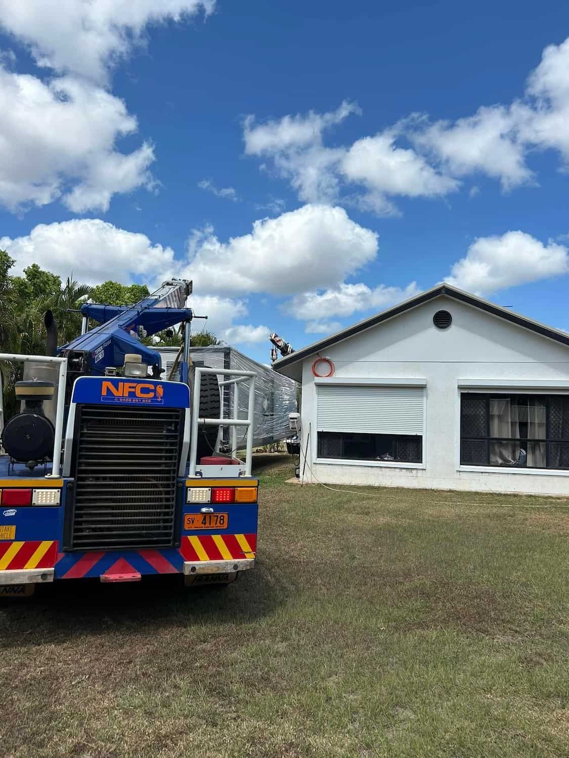 A Blue Truck Is Parked in Front of A White House — Northern Franna Cranes NT in Noonamah, NT