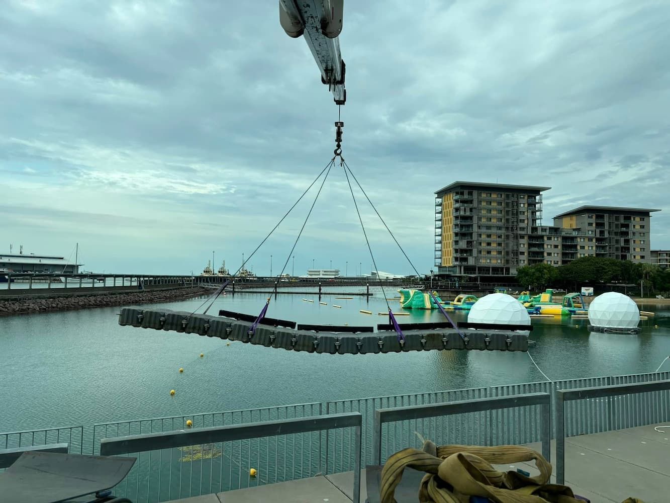 A Crane is Lifting a Large Object Over a Body of Water — Northern Franna Cranes NT in Noonamah, NT