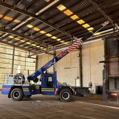 A Blue Truck with A Crane on The Back Is Parked in A Warehouse — Northern Franna Cranes NT in Noonamah, NT