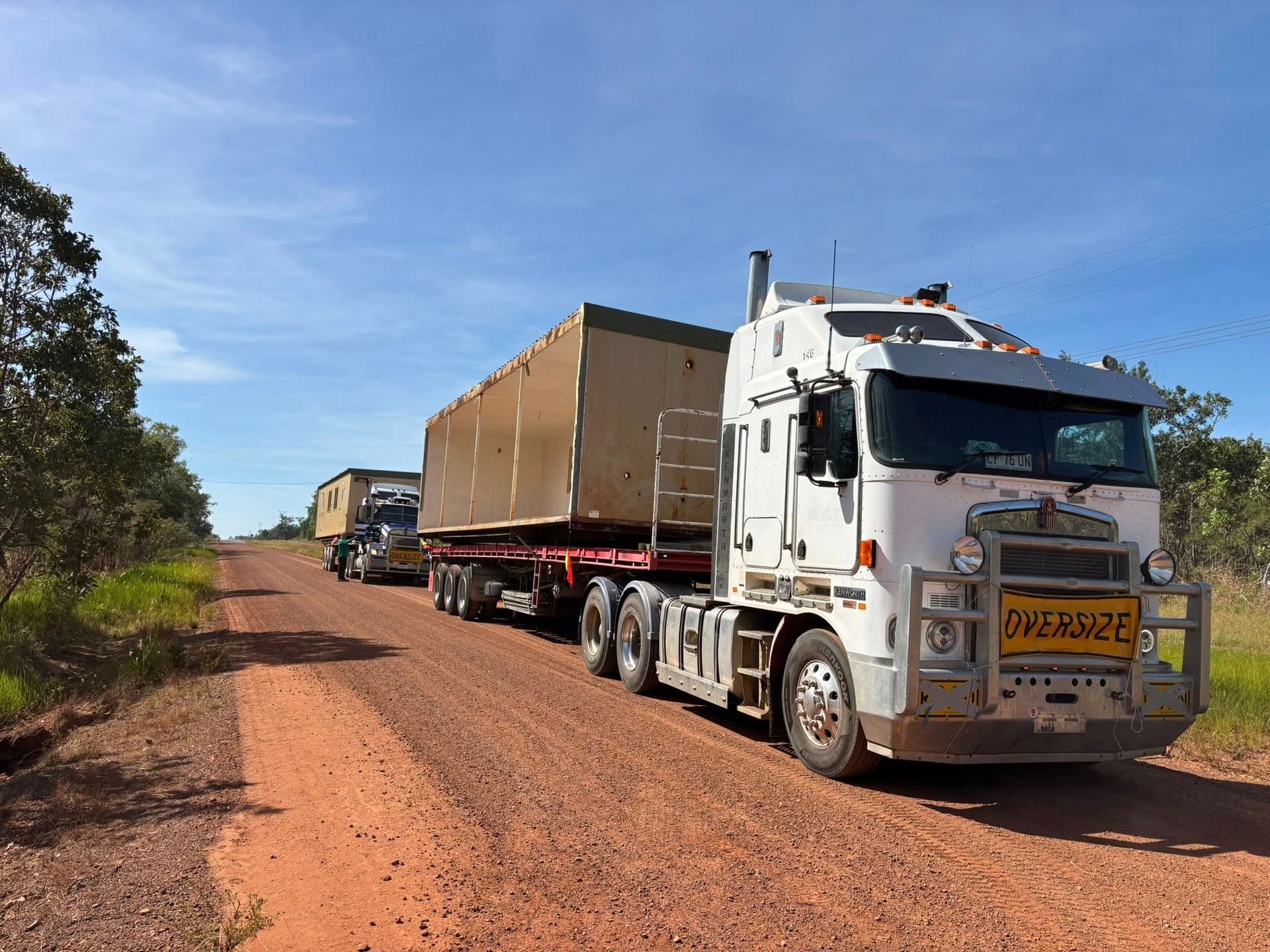 Three oversized trucks are driving on a dirt road— Northern Franna Cranes NT in Noonamah, NT