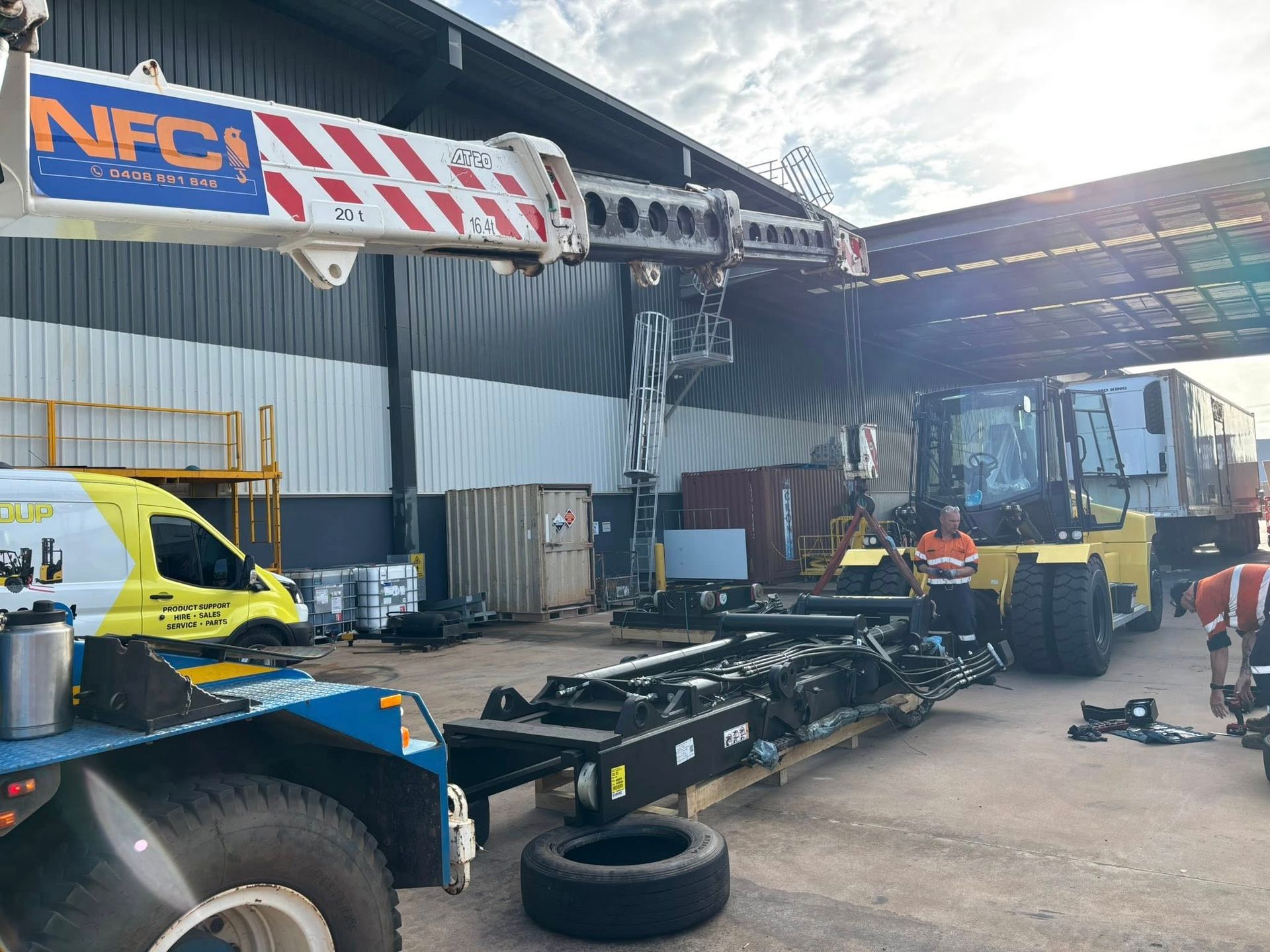A Large Crane Is Parked and A Man Is Standing Behind It — Northern Franna Cranes NT in Noonamah, NT