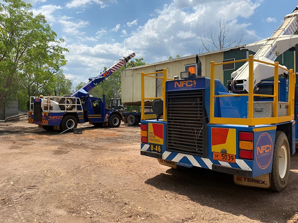 Two Blue Trucks-Mounted Cranes