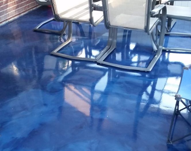 Blue, shiny epoxy-coated deck with outdoor furniture. Blue, shiny epoxy-coated deck with outdoor furniture.