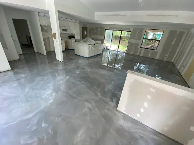 Newly renovated interior with a metallic epoxy floor in a gray and white swirl pattern.