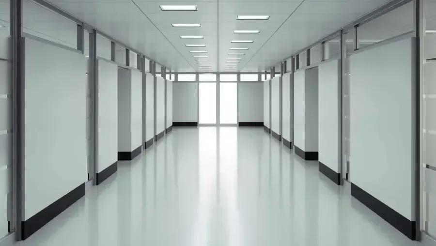 Empty, bright hallway leading to a bright window at the end. Empty, bright hallway leading to a bright window at the end.