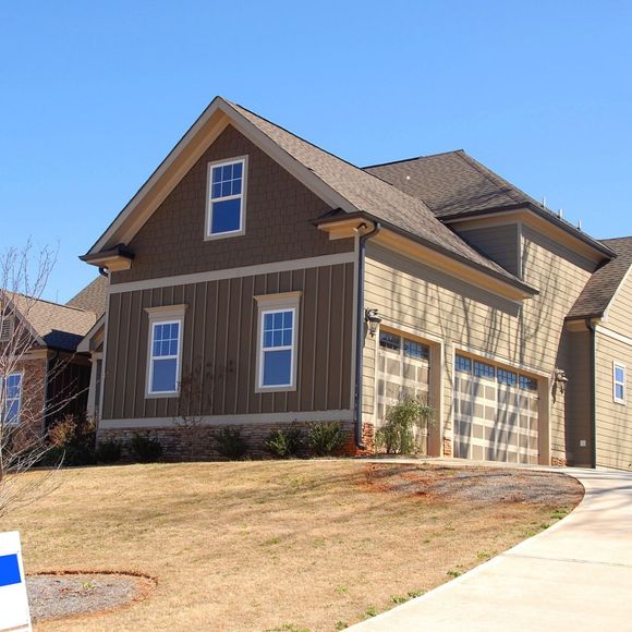 A house with a lot of windows is for sale